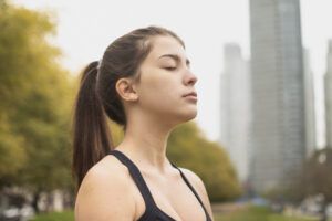 Chica respirando en el ambiente tóxico de la ciudad